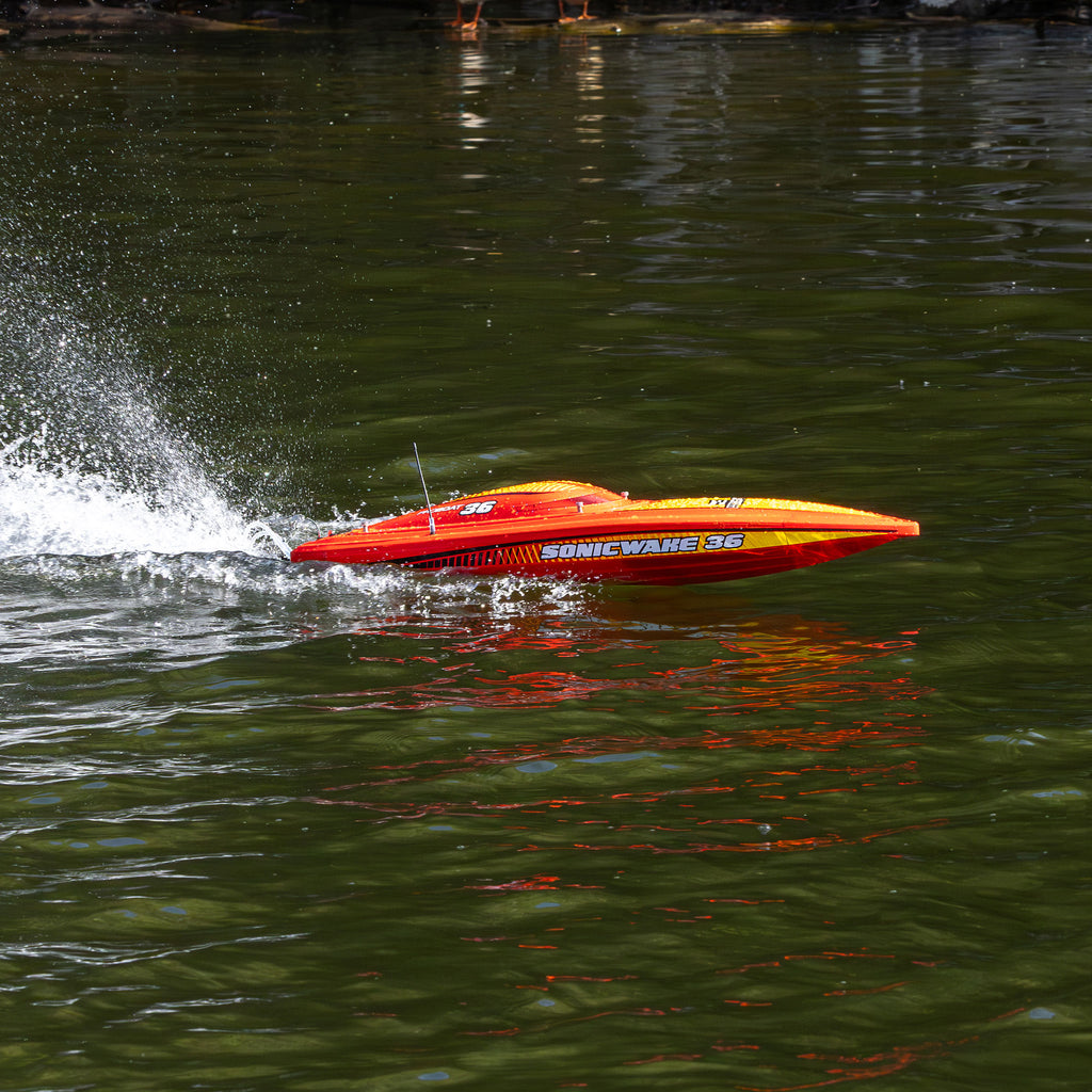Pro Boat Sonicwake 36 V3 RTR, red, PRB-2171T2, side view at speed with spray