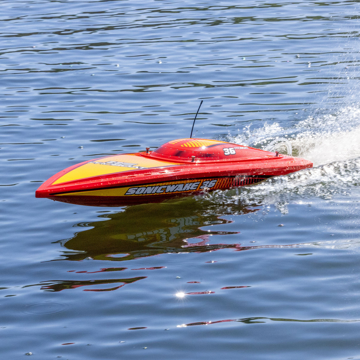 Pro Boat Sonicwake 36 V3 RTR, red, PRB-2171T2, running on the water, bow side view